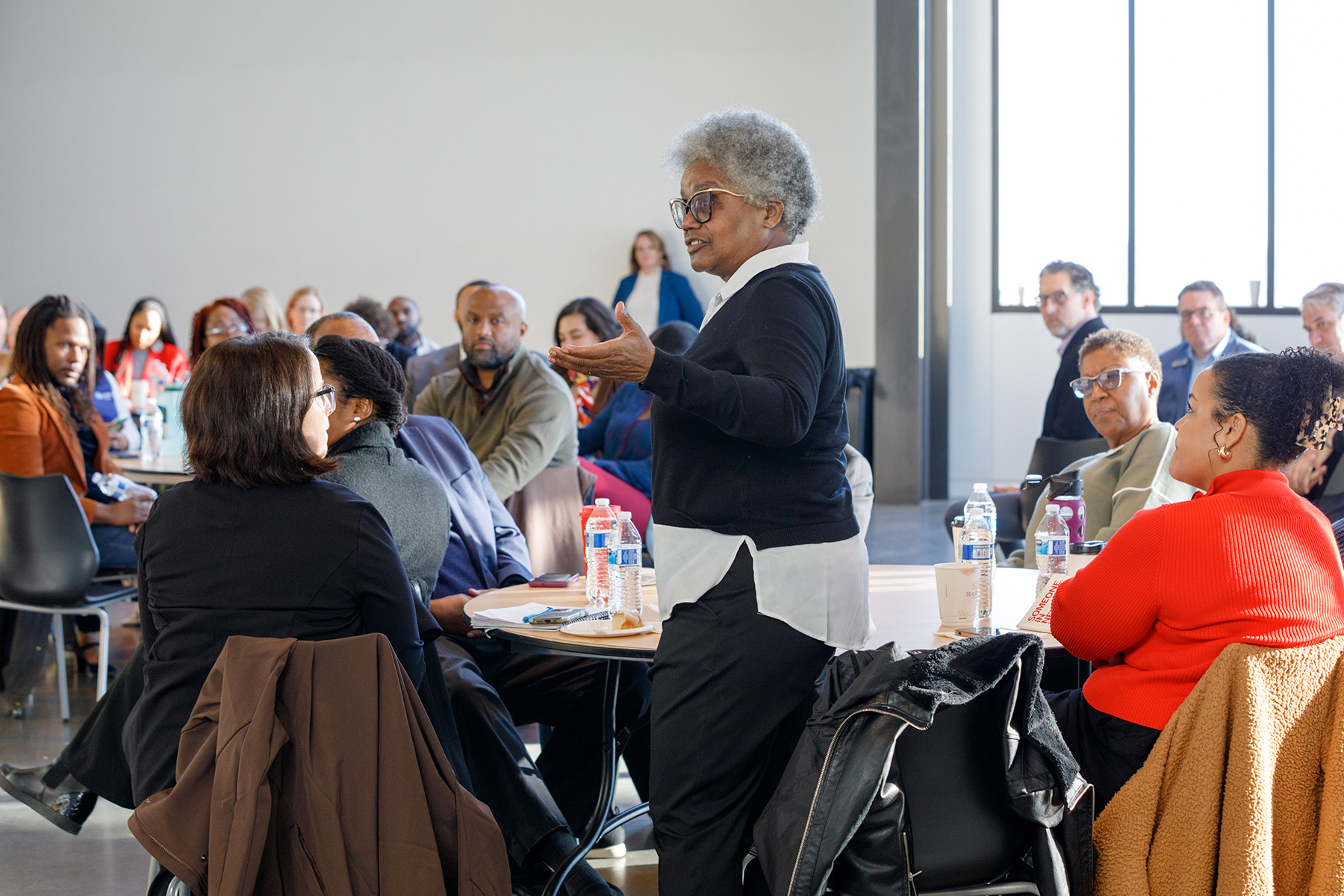 North Omaha community member stands during meeting and speaks to group