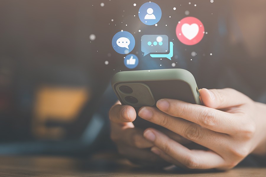 Person holding smart phone scrolling through social media