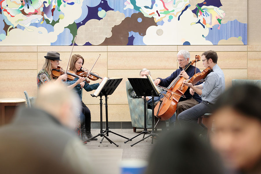 The UNO Maverick Quartet performs in the lobby of the Fred & Pamela Buffett Cancer Center.