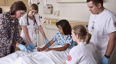 Nursing instructor and students in learning resource center
