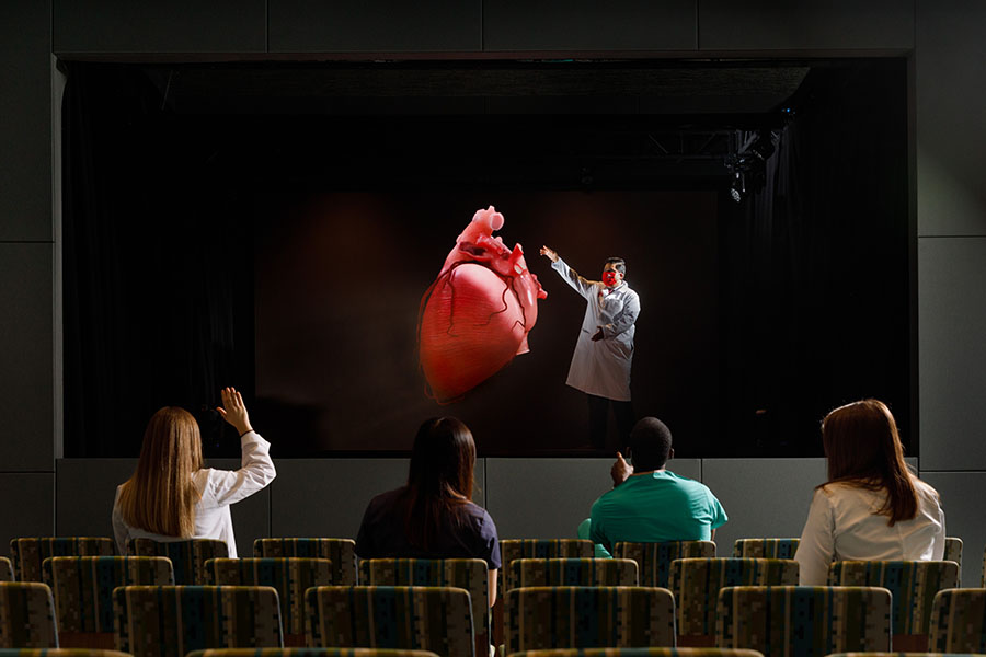 Students view a hologram of a heart in Davis Global Center's holographic theater 