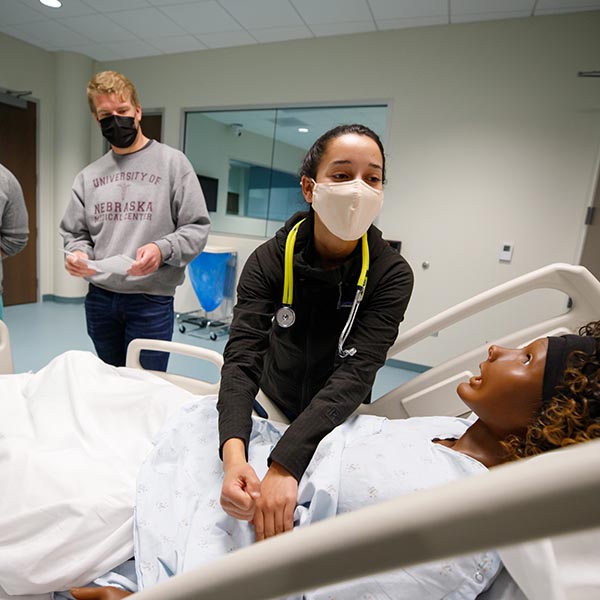 Medical students work with a simulator