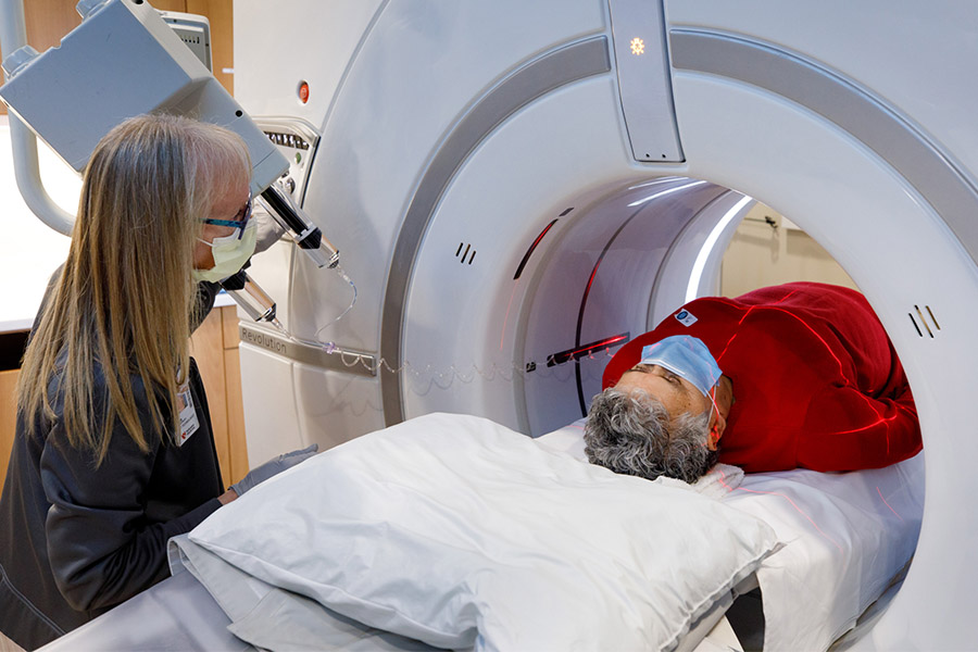 Debora York, CT scan technician, positions Maria Alvarran for her CT scan.