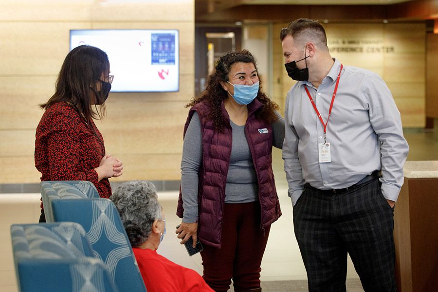 Maria Alvarran and her family members are greeted by her doctor and a clinical trials analyst serving as an interpreter at the Fred & Pamela Buffett Cancer Center. Maria is a non-English speaking patient enrolled in a clincial trial.