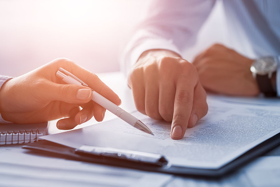 People looking at legal documents on a desk