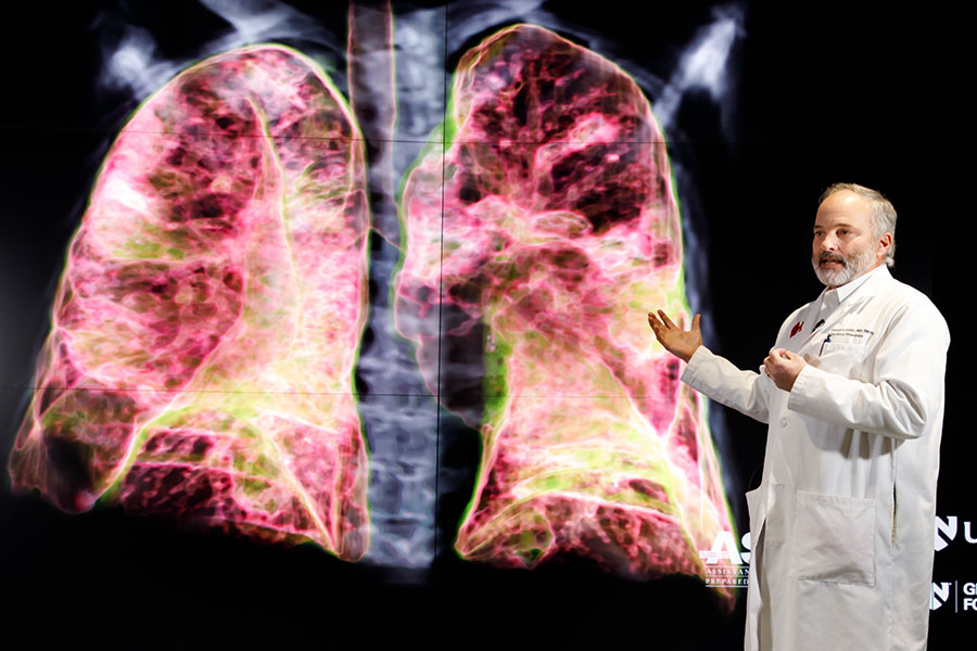 Faculty member teaching in front of 3D model of lungs