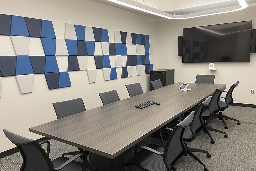 Conference room featuring table, chairs, and large monitor