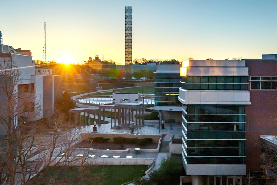 UNMC campus buildings with sun rising in background