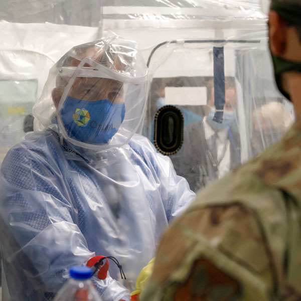 Trainees in biocontainment outfit