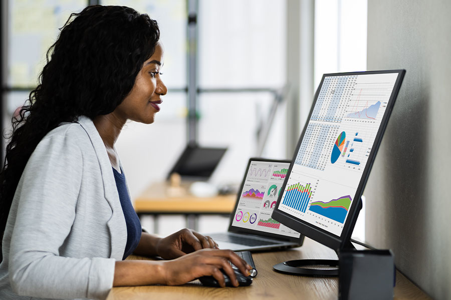 Woman sitting at computer looking at data