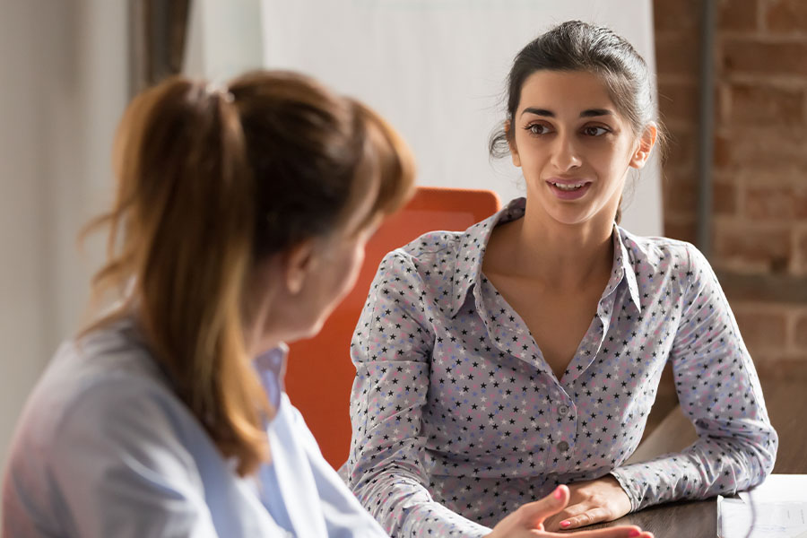 Two women talking seriously around a table