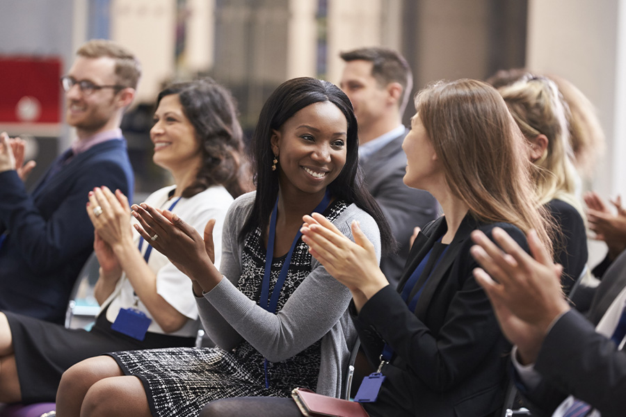 People clapping after a conference presentation