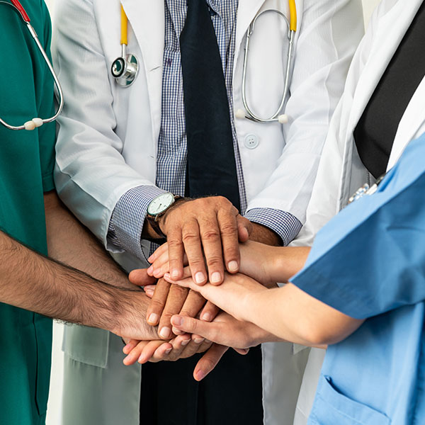 interprofessional team holding hands