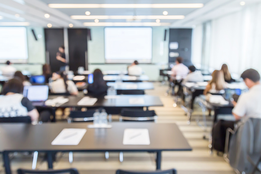 Teacher stands in front of class