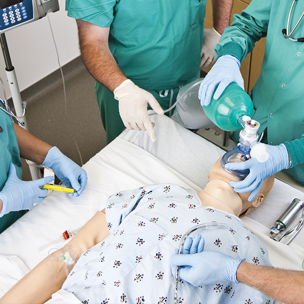 students in sim lab learning on a dummy