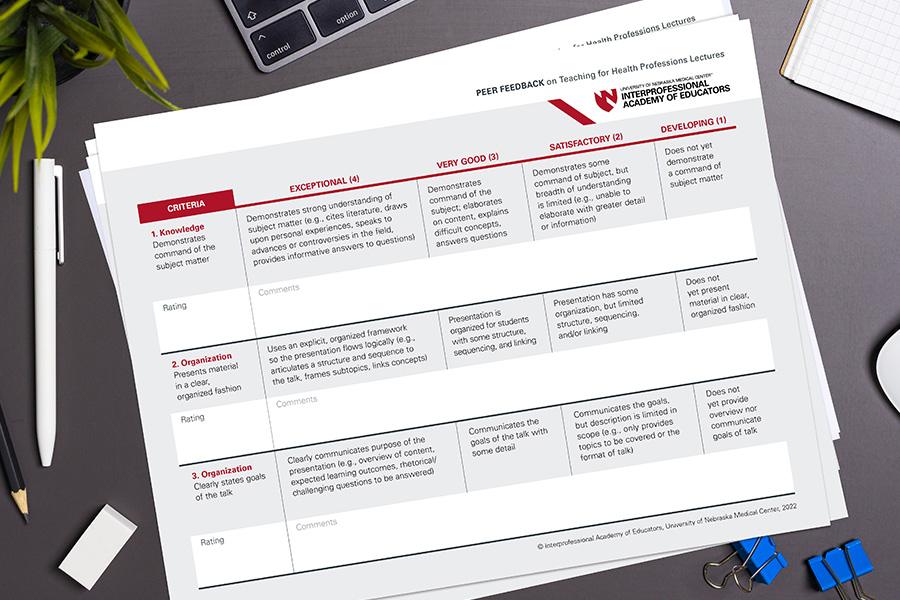 Peer feedback on teaching rubric sitting on a desk