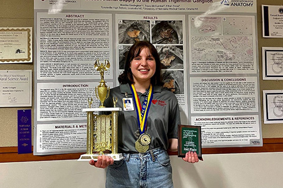 Annika Covington posing with her 10 awards