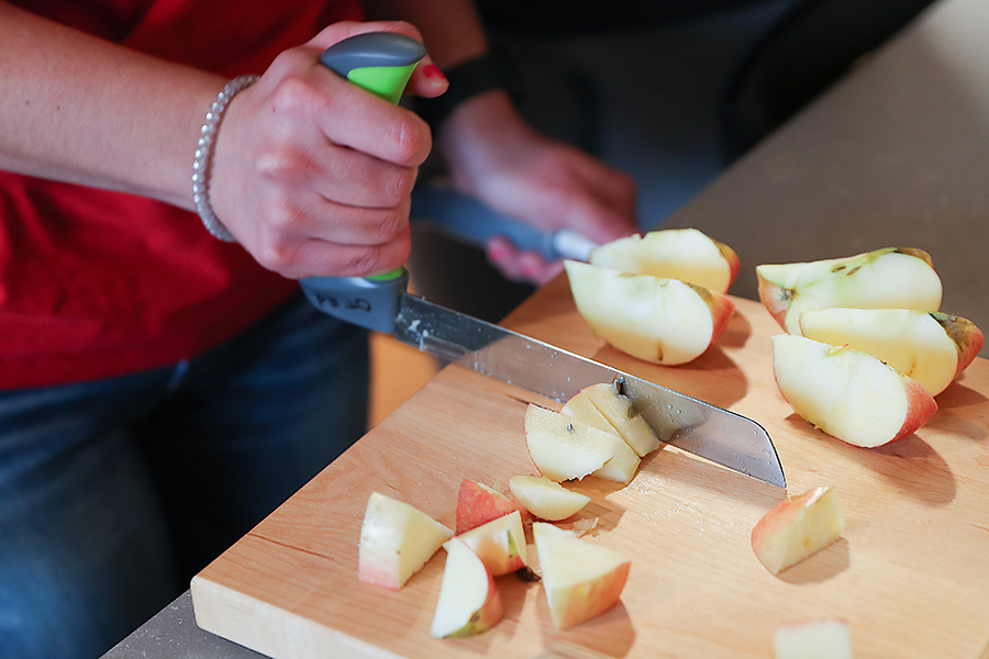 OT helps client use apple slicer