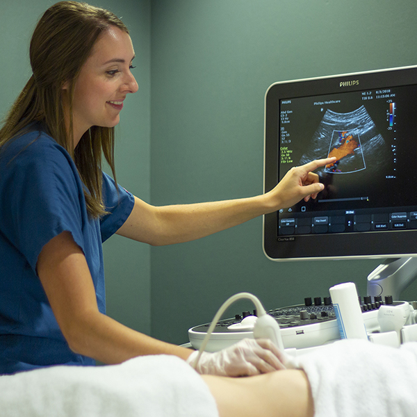 Sonography student scanning