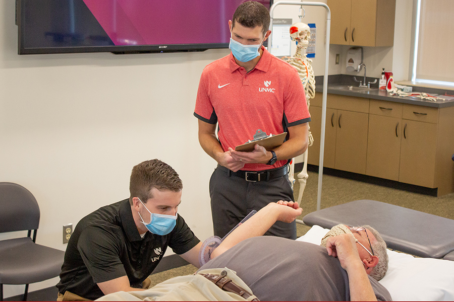 Resident works with mentor and standardized patient