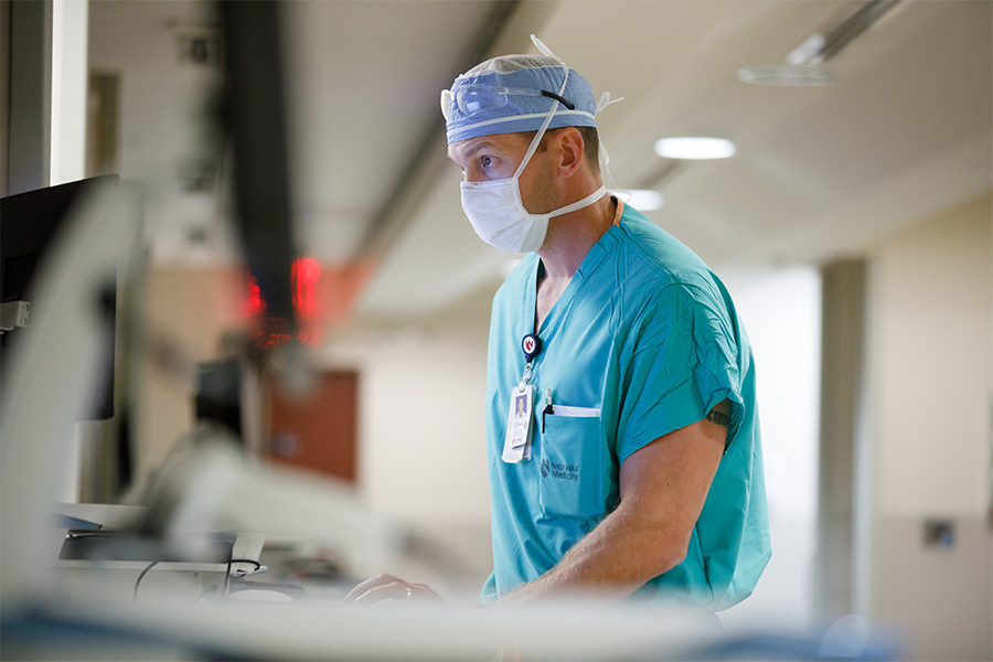 Anesthesiologist entering data into computer