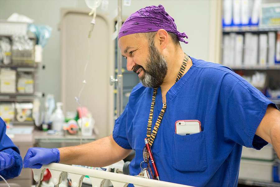 Pediatric anesthesiologist smiles down at patient.