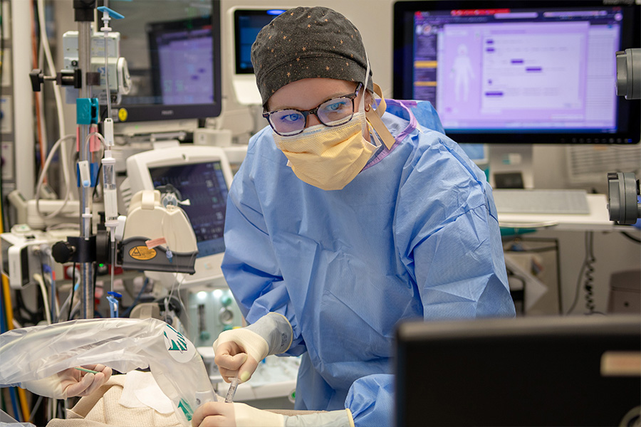 Female pediatric anesthesiologist in OR administering care. 