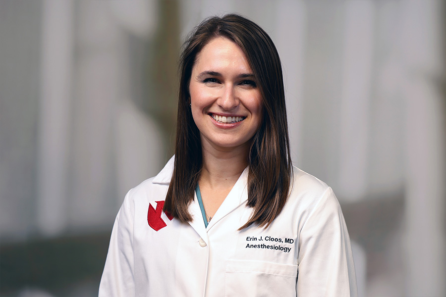 Erin Cloos, MD, headshot with white lab coat
