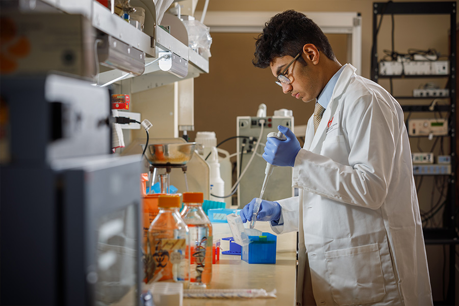 Researcher working with lab equipment