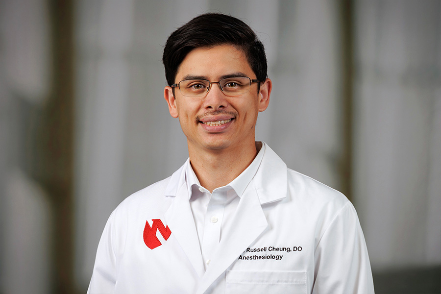 Andrew Russell Cheung, DO, headshot with white lab coat