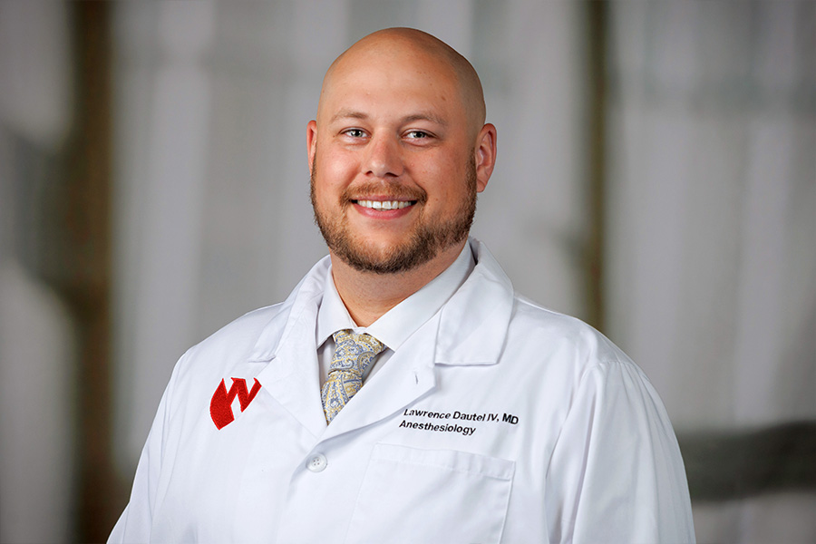 Lawrence Dautel, MD, headshot with white lab coat