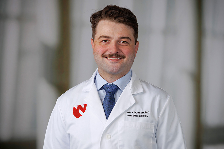 Alexander Duncan, MD, headshot in white lab coat