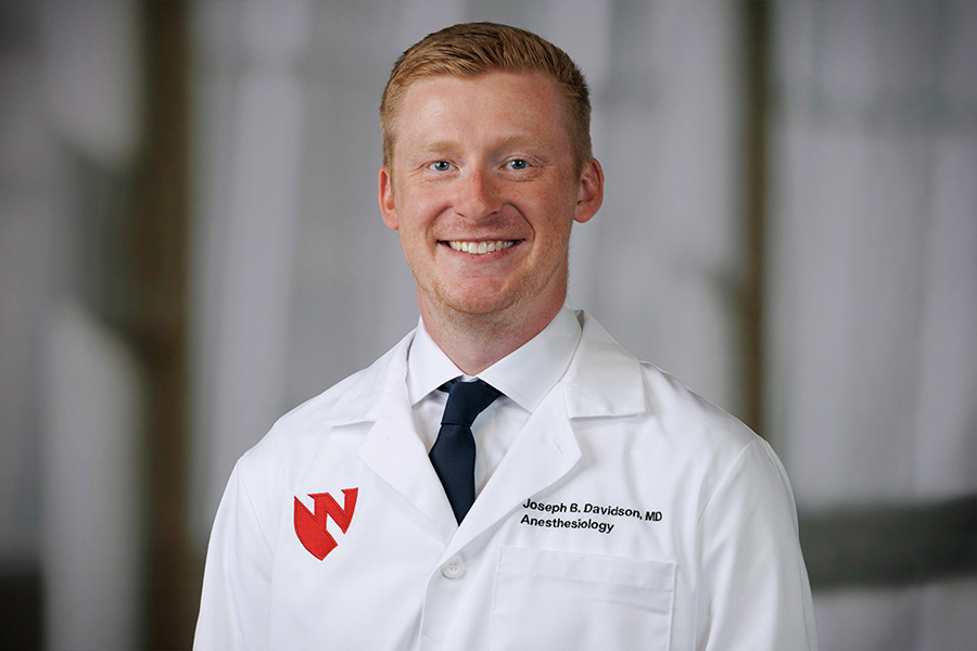 Joseph Davidson, MD, headshot in white lab coat