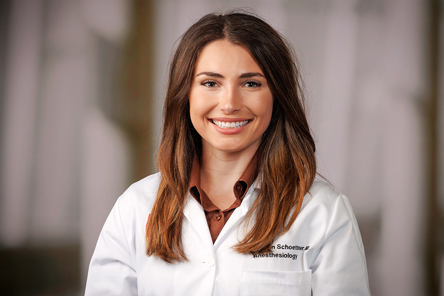 Kaihlen Schoettmer, MD, headshot in white lab coat