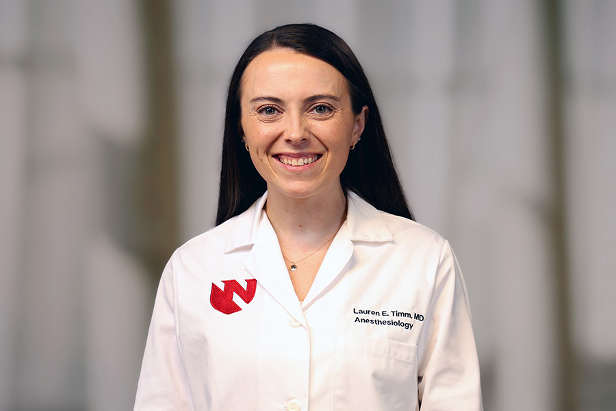 Lauren Timm, MD, headshot in white lab coat