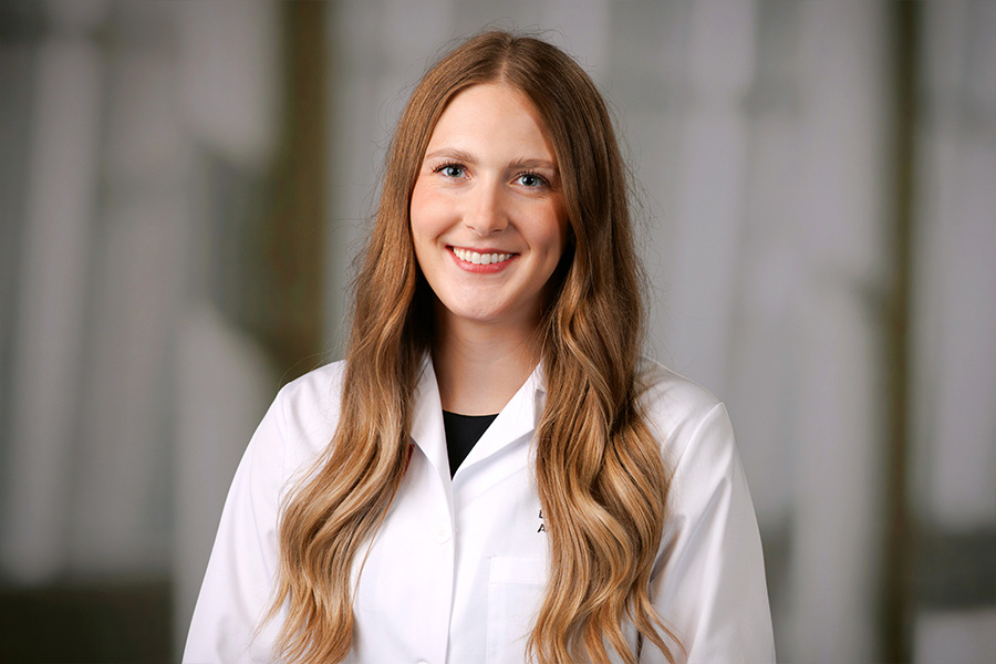 Lauren McGill, MD, headshot in white lab coat