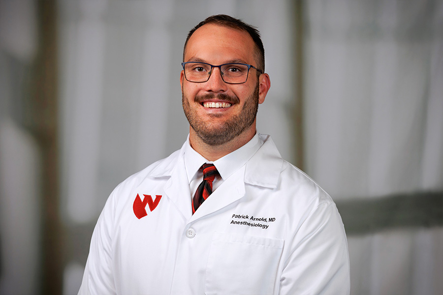 Patrick Arnold, MD, headshot in white lab coat
