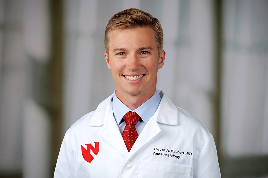 Trevor Daubert, MD, headshot in white lab coat