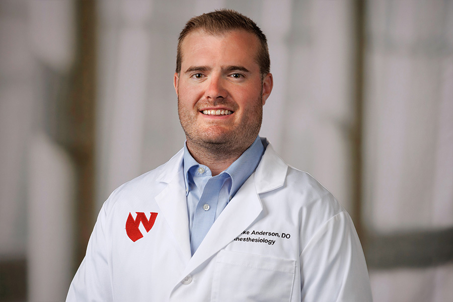 Lueke Anderson, DO, headshot with white lab coat