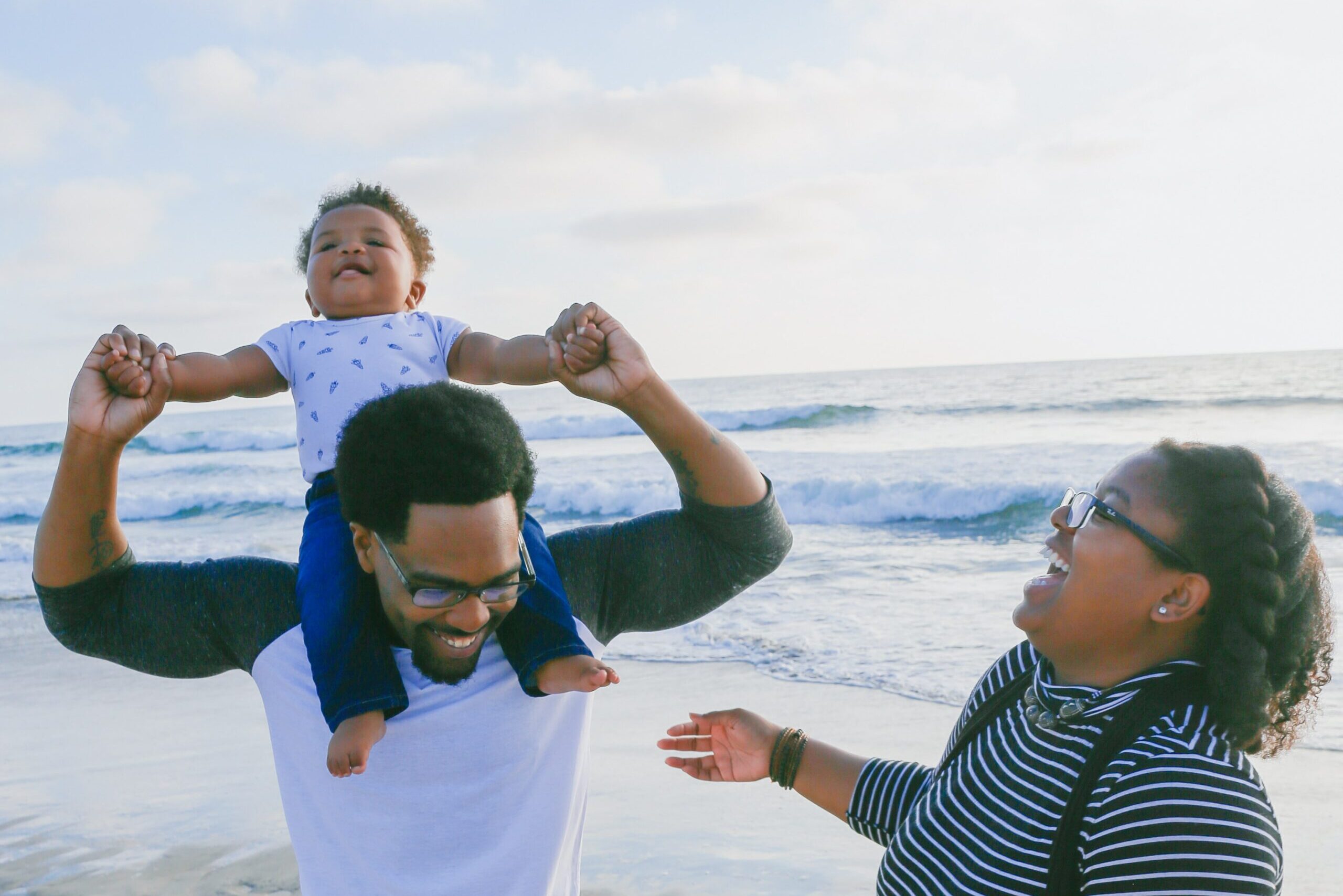 Father, mother, and child at the beach