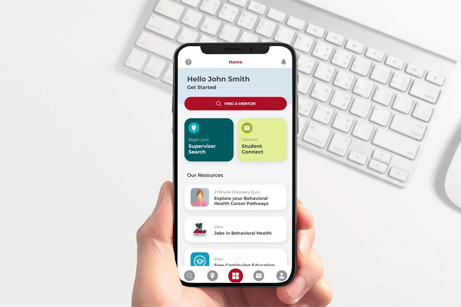 A person holds up a mobile phone displaying the Behavioral Health Careers App