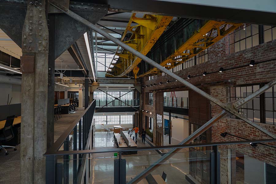 Photo by Ani Schutz for Silicon Prairie News of interior of the Catalyst building, showing a sleek, urban environment in a historic rehabbed steelworks building.