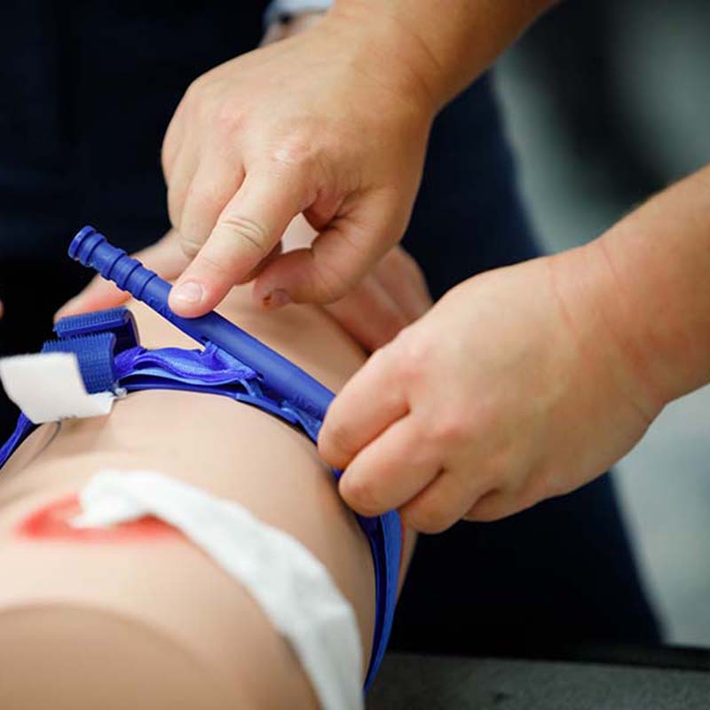 Simulated arm with a tourniquet during stop-the-bleed training.