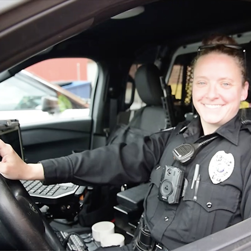 Female police officer in her cruiser.