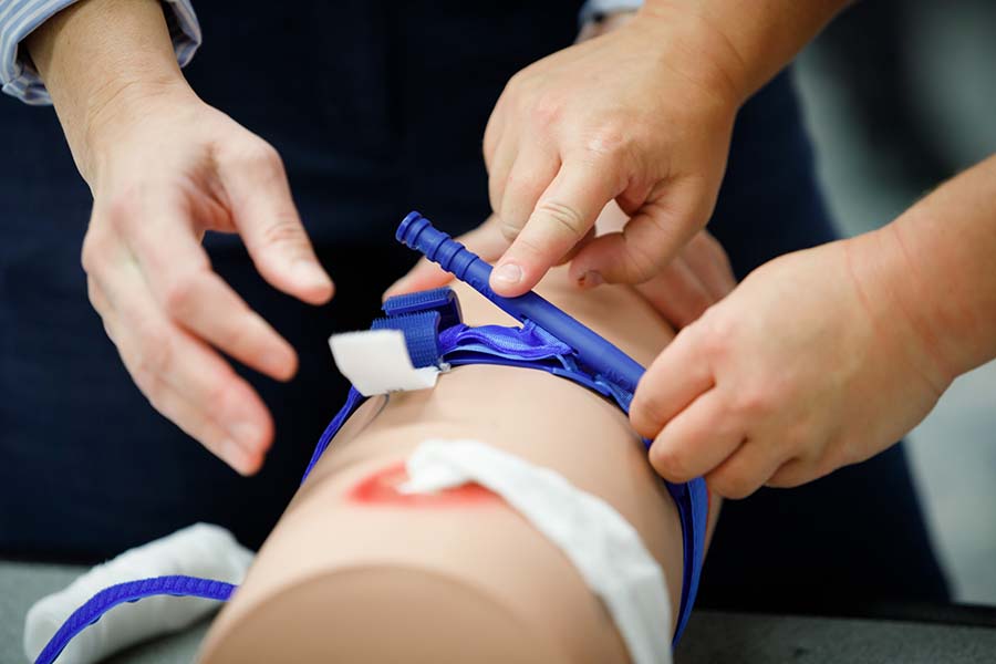 During Stop the Bleed training, a simulator is used with a tourniquet.