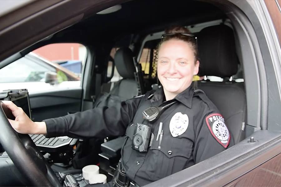 A female UNMC police officer in her cruiser.
