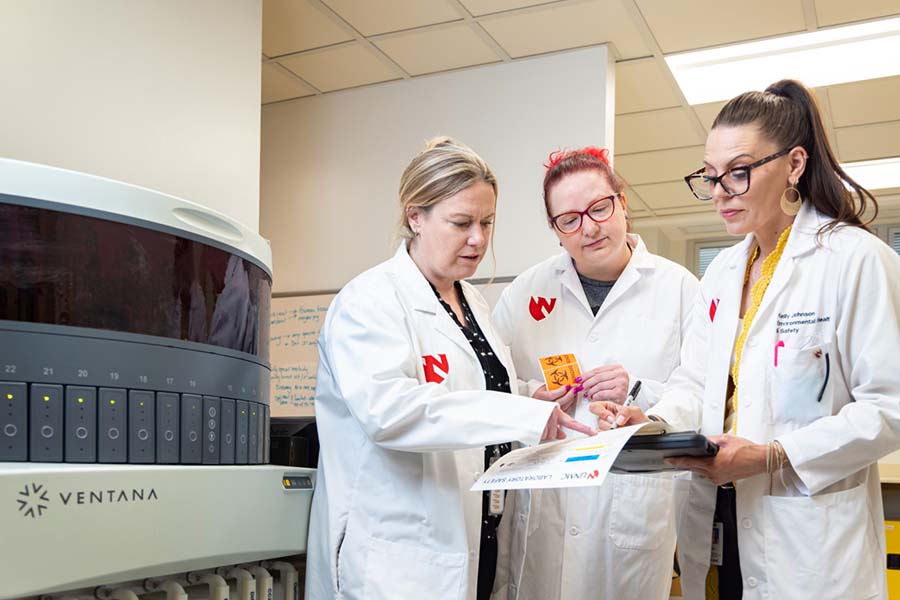 UNMC researchers look through a hazardous materials guide