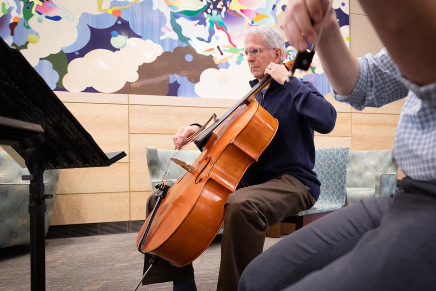 A quartet member plays in the cancer center lobby.