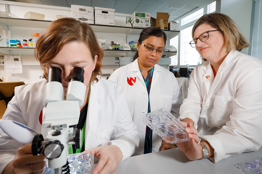 Group or researchers with microscope