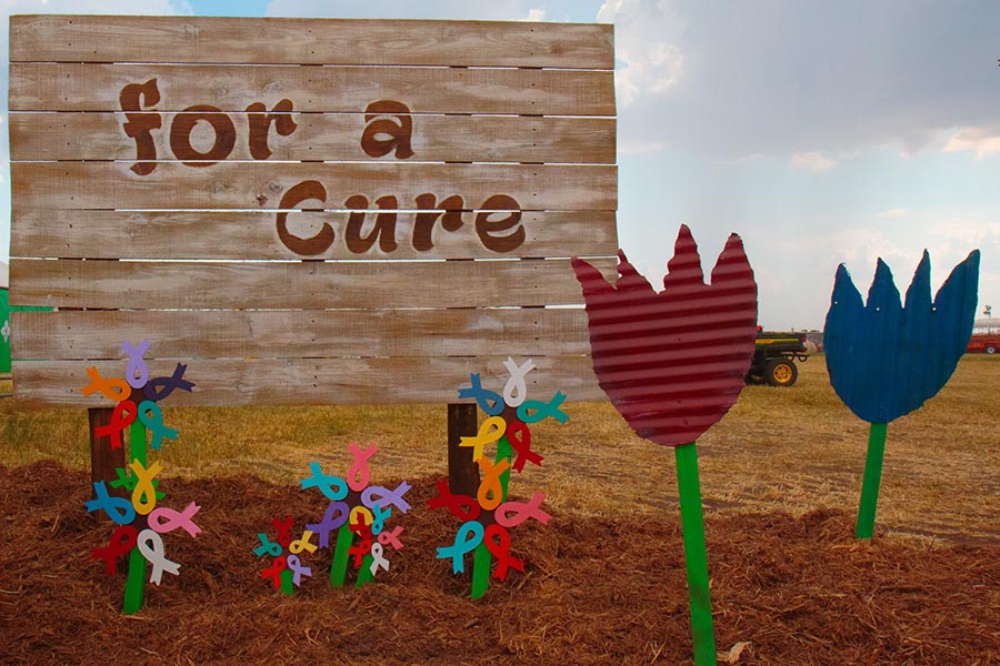 "For a Cure" on an event sign